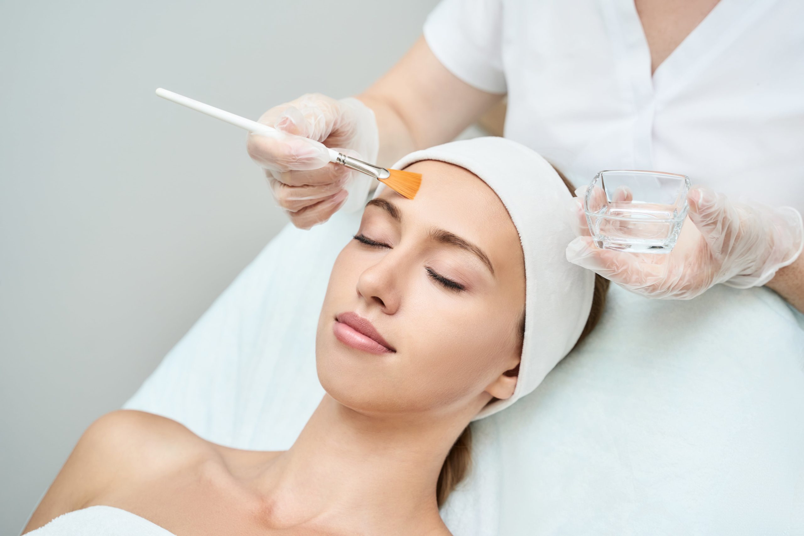 Beautiful Female Getting Chemical Peel Treatment from Esthetician | Cosmedics MedSpa in Lehi, UT